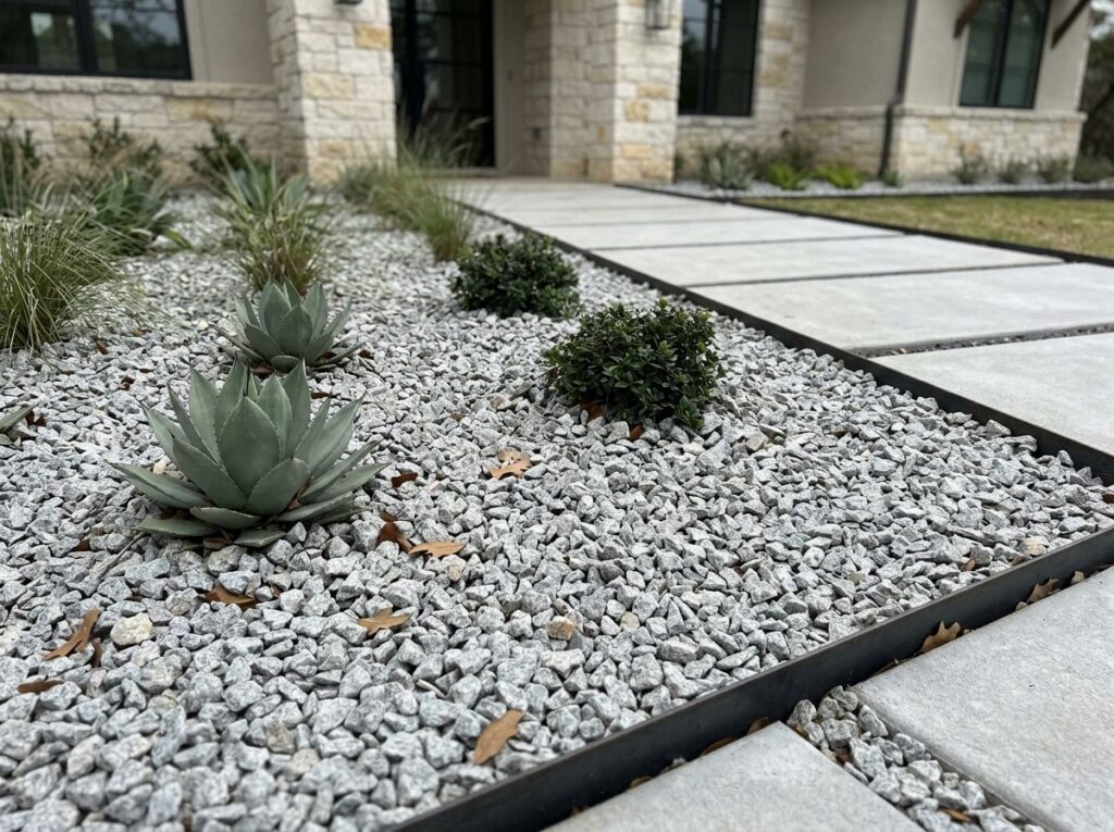 Granite Chips ground cover of light gray stone pieces spread evenly for landscaping.